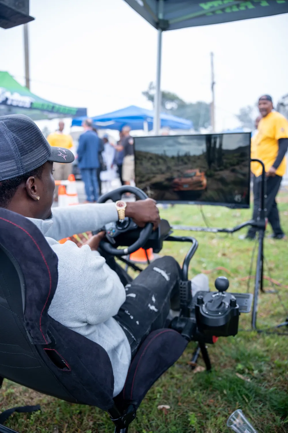 Adult guest racing on the simulator at an NYC community event
