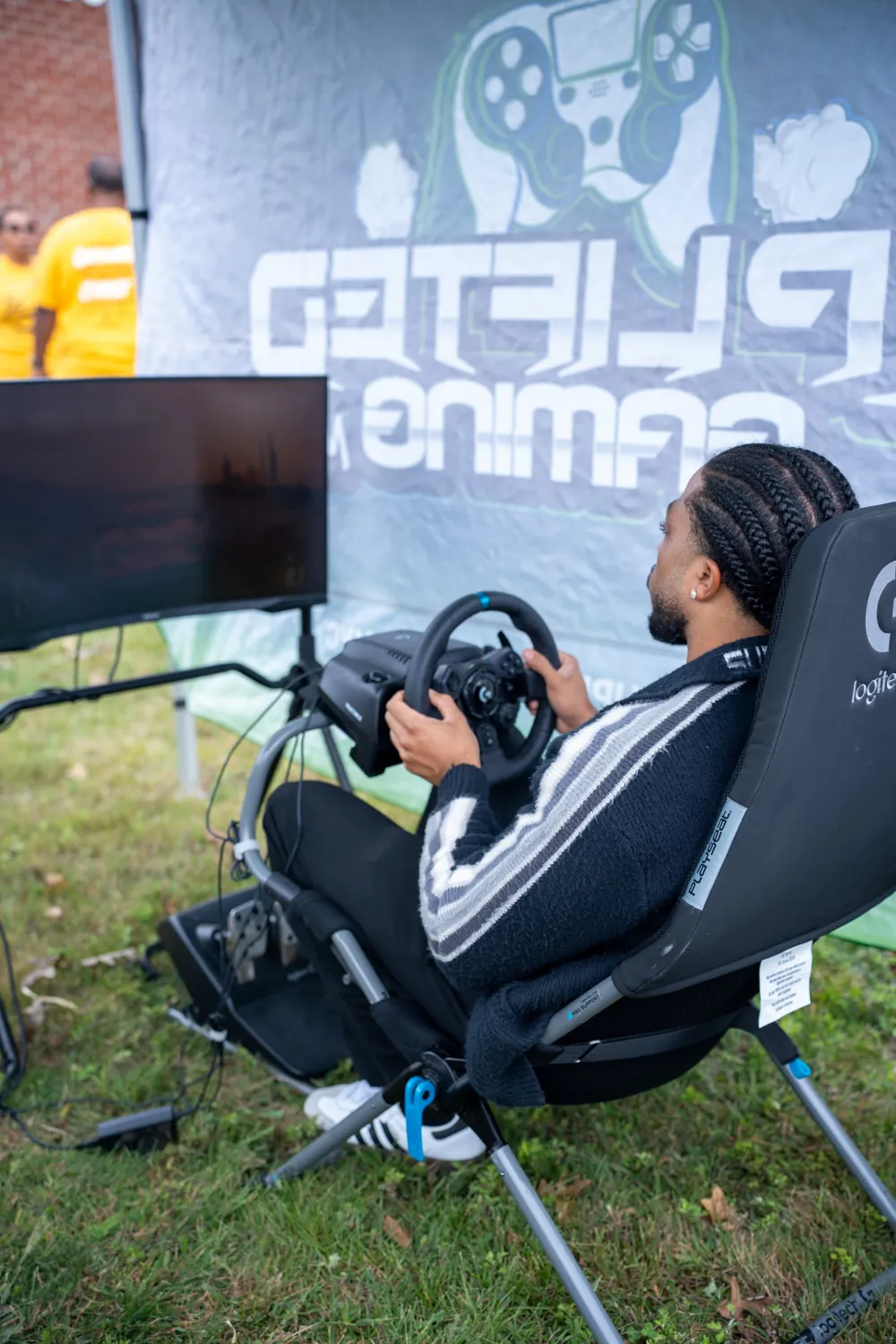 Guest racing in front of the Uplifted Gaming NYC backdrop