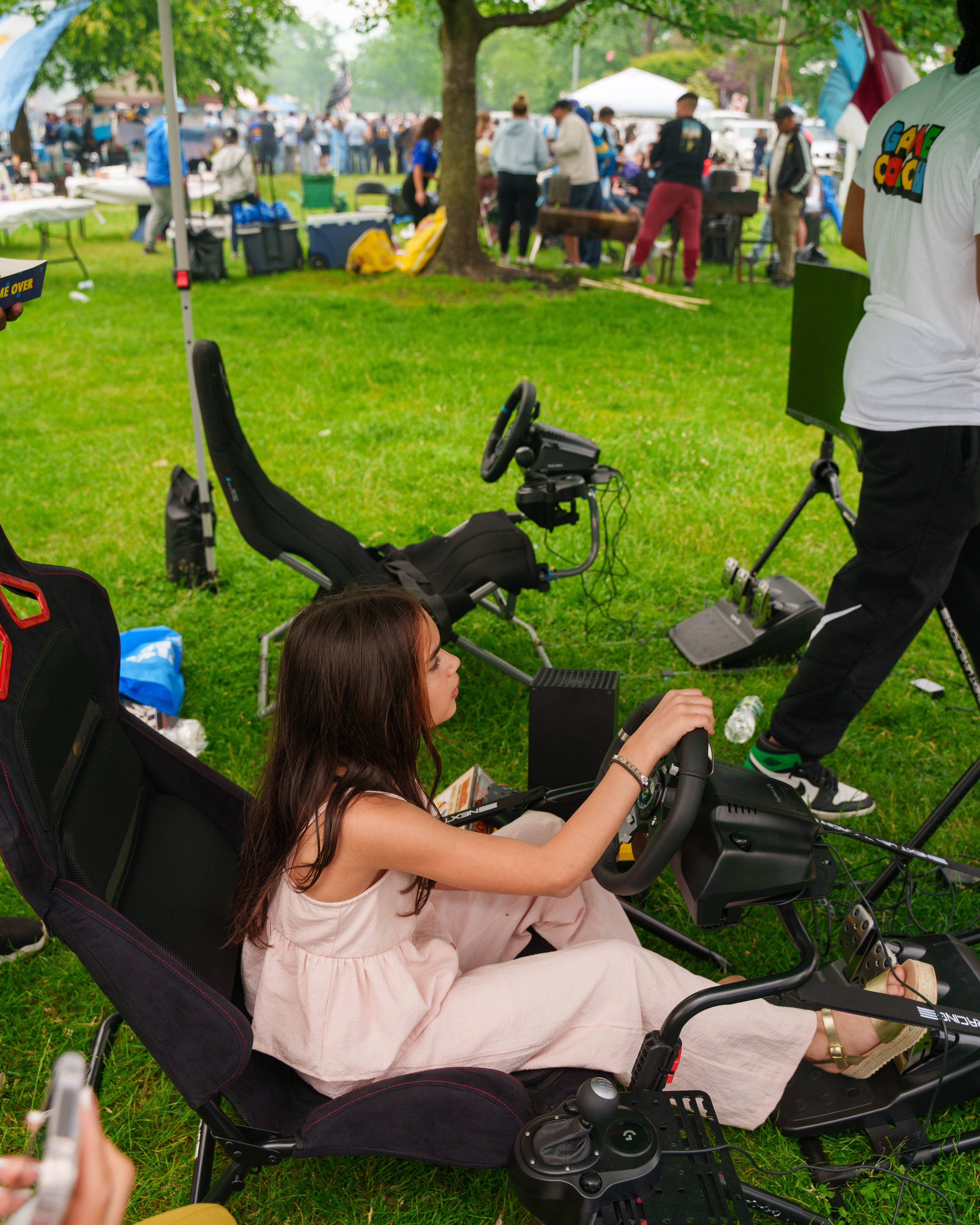 Guest enjoying the racing simulator at an outdoor event