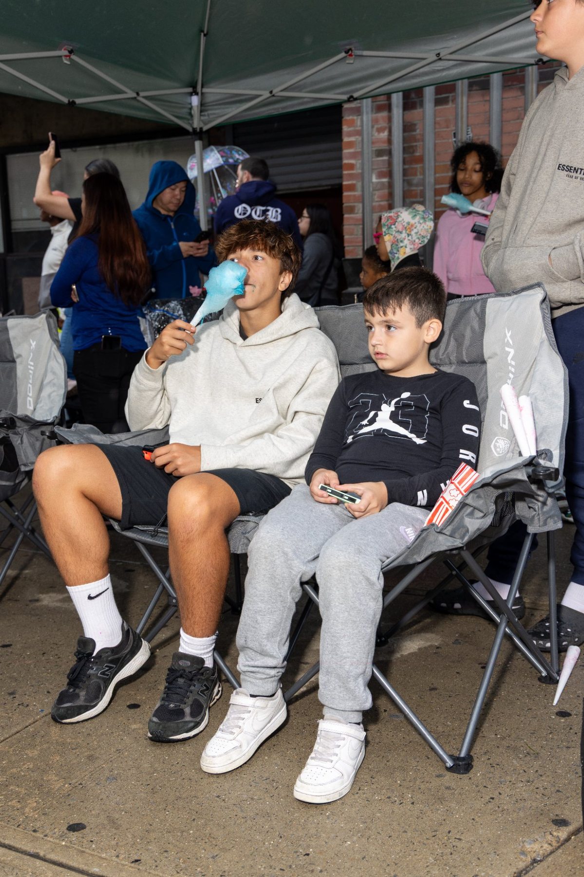 Teens enjoying cotton candy at the event